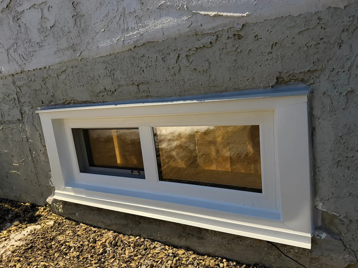 Completed window installation viewed from outside with proper sealing and trim