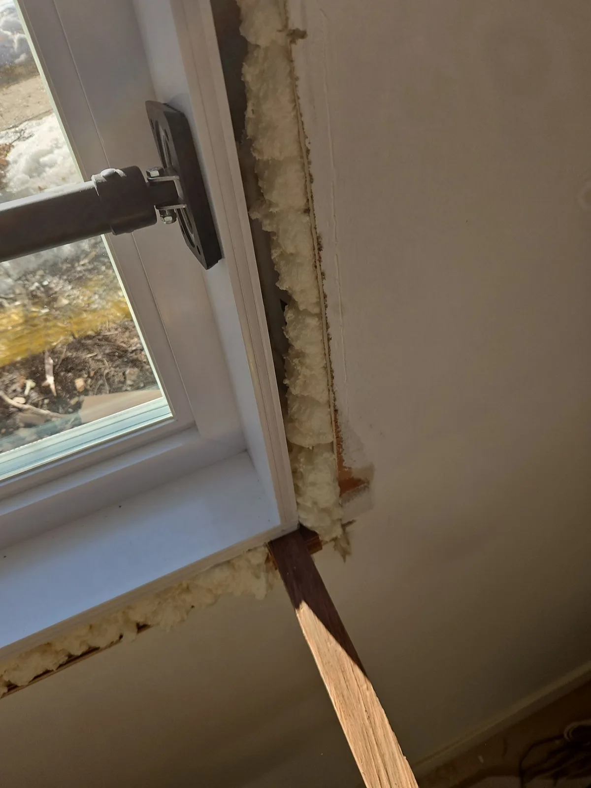 Close-up of proper window shim placement during installation