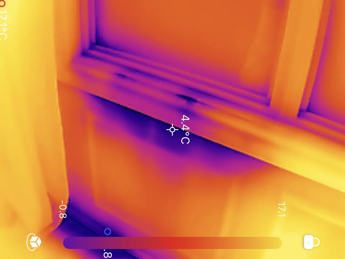 Thermal camera image showing cold air leak at 4.4°C around window corner
