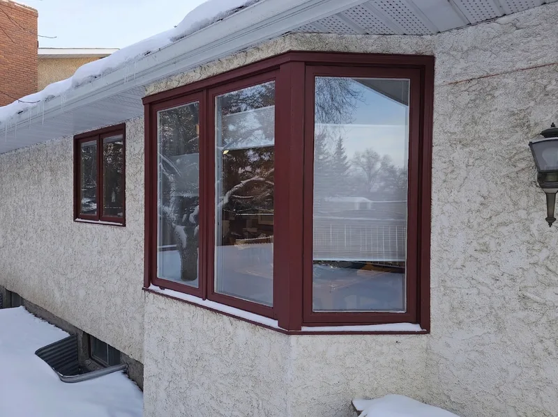 Old bay window with burgundy frame