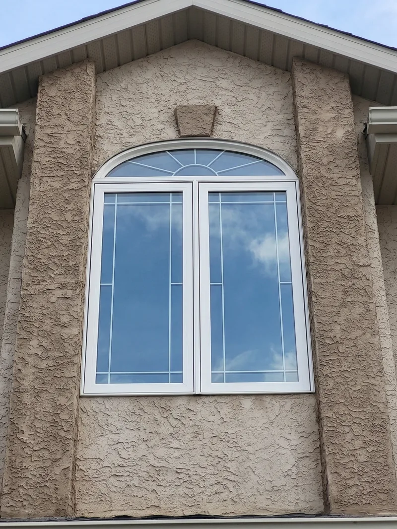 Arched casement window with clear glass